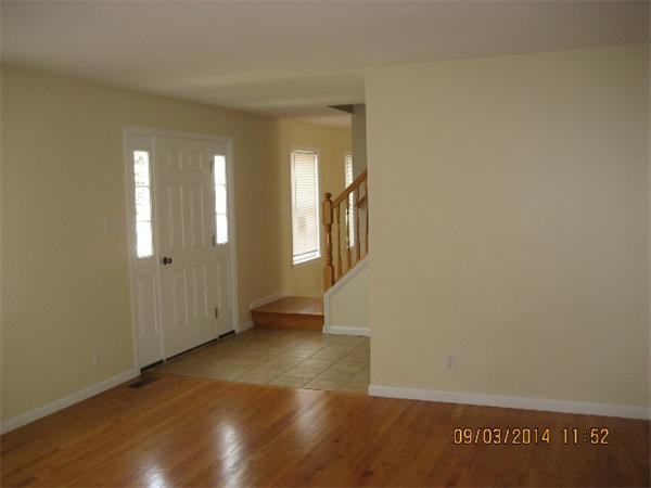 918 Jefferson Street Fall River, MA 02721 - Photo 5 of 6 an empty room with wooden floor and windows