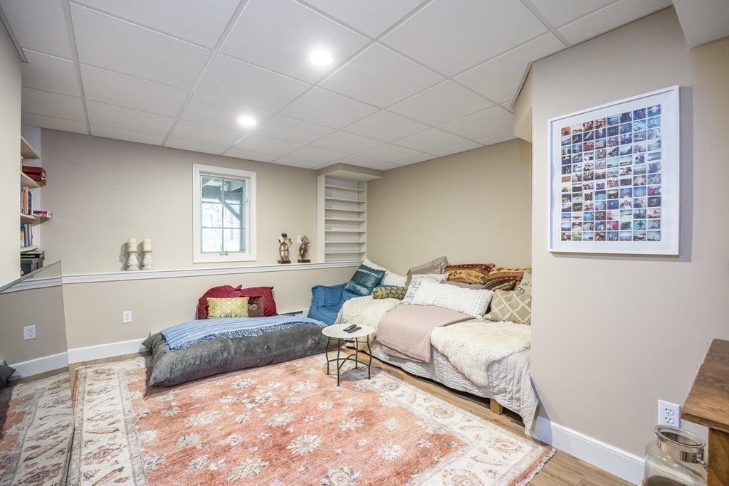 121 Beech Leaf Island Road Centerville, MA 02632 - Photo 36 of 42 a spacious bedroom with a bed a couch and a window