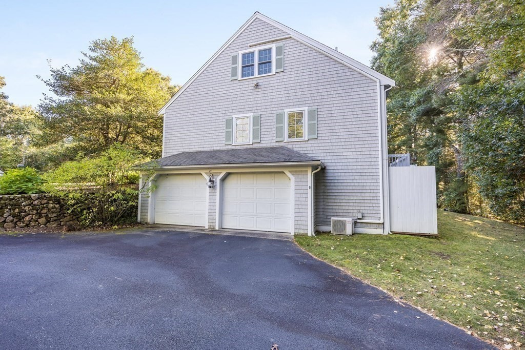 121 Beech Leaf Island Road Centerville, MA 02632 - Photo 4 of 42 a front view of a house with a yard and garage