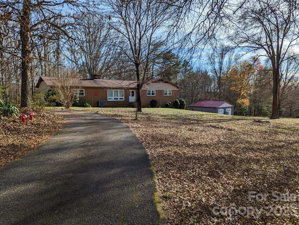 a front view of a house with a yard and trees