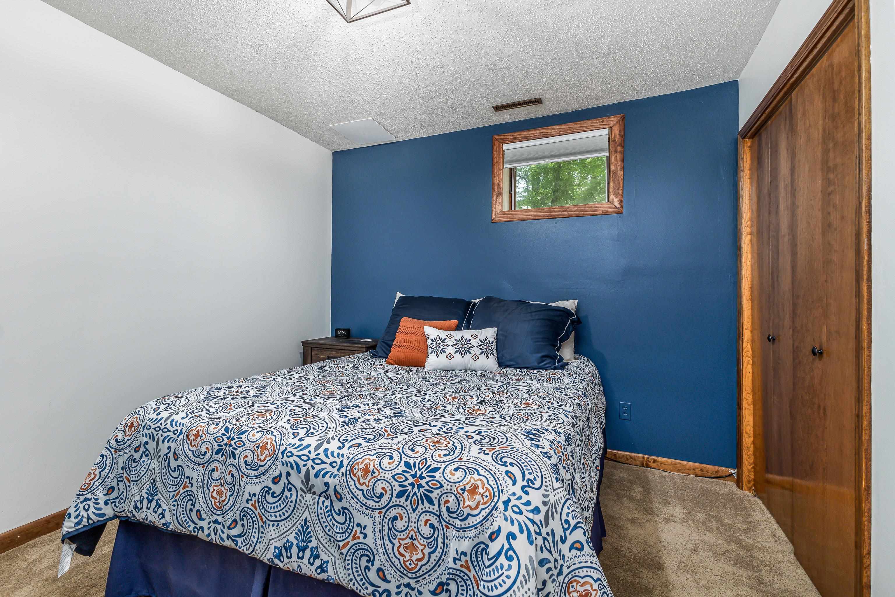 4 Colony Court Galena, IL 61036 - Photo 5 of 32 a bedroom with a bed and painting on the wall