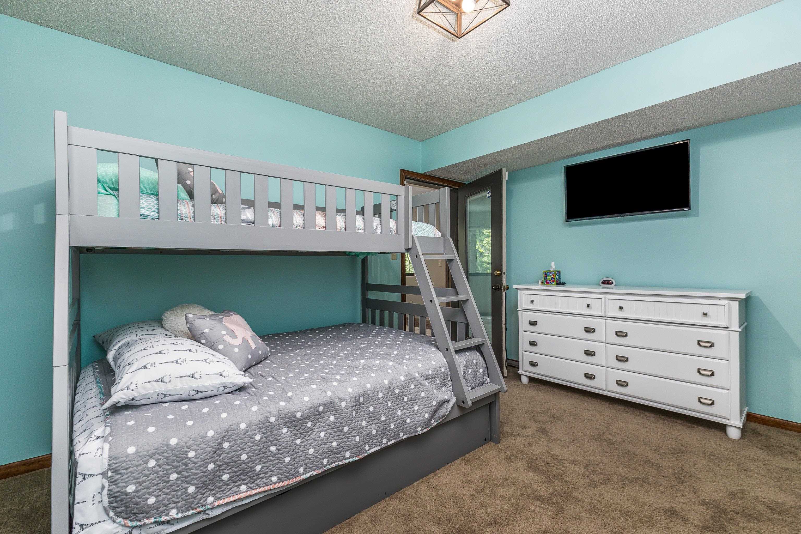 4 Colony Court Galena, IL 61036 - Photo 10 of 32 a bedroom with a bed and a flat tv screen on wall