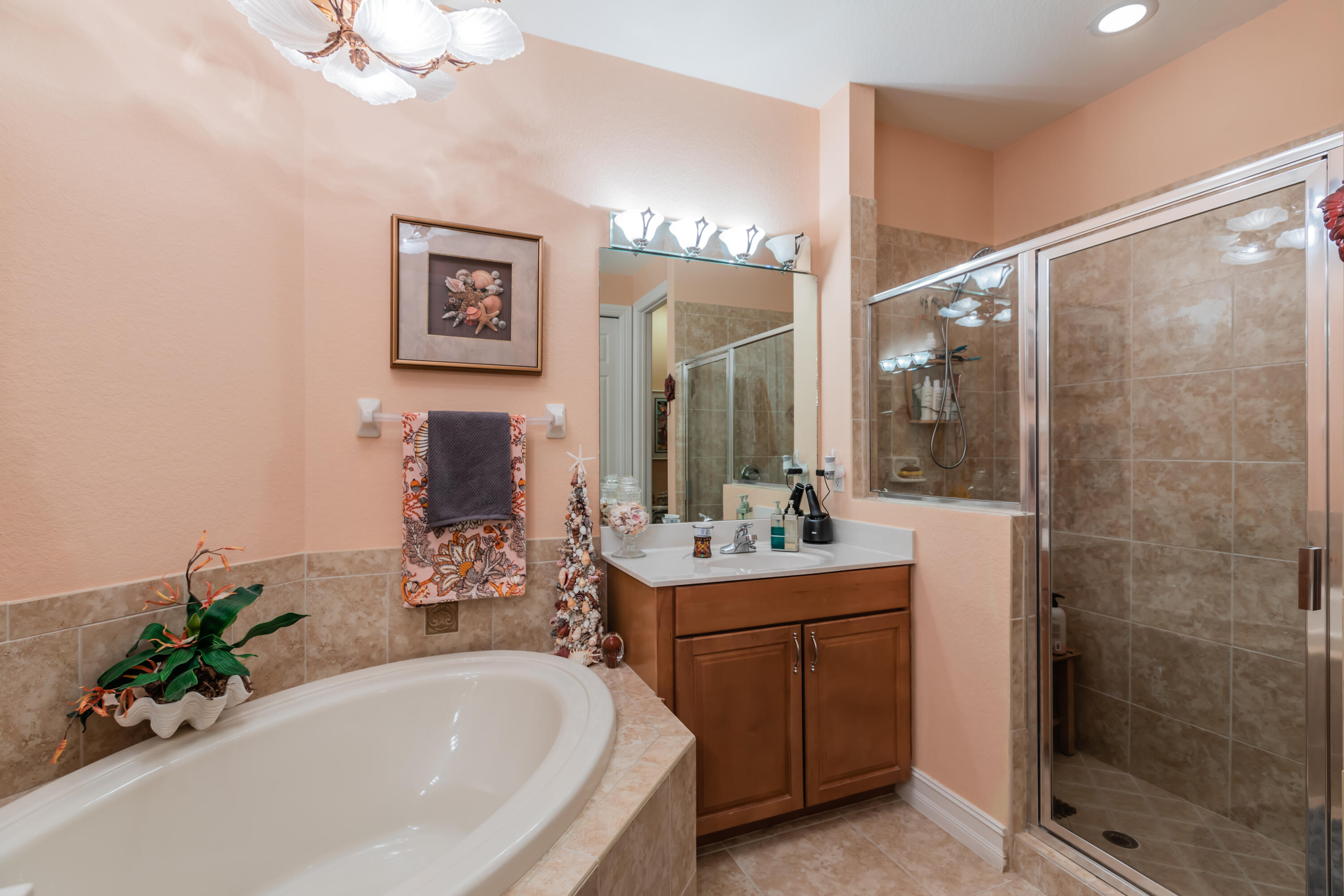 14728 Cranberry Naples Naples, FL 34114 - Photo 11 of 26 a bathroom with a bathtub sink and mirror