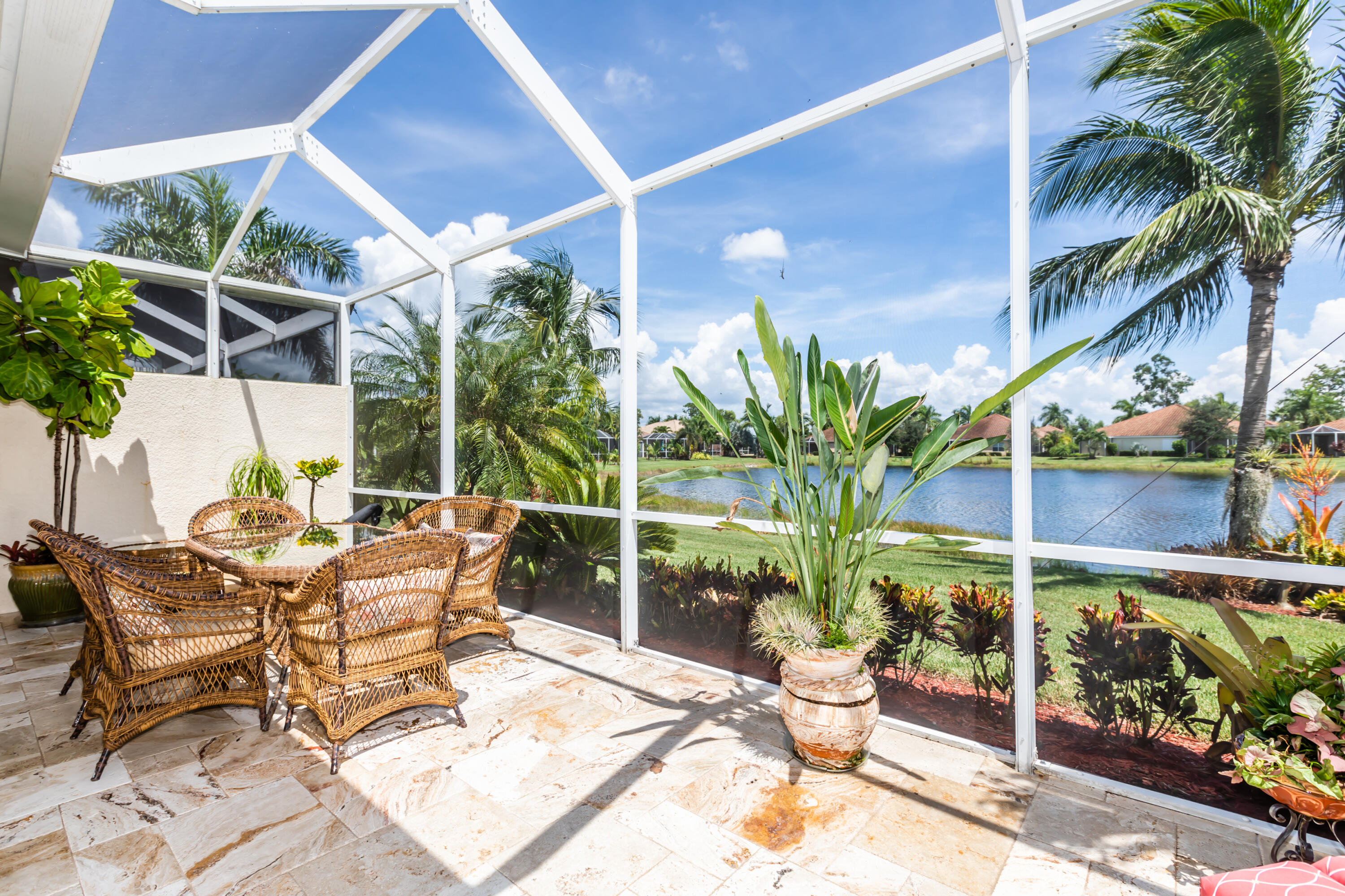 14728 Cranberry Naples Naples, FL 34114 - Photo 5 of 26 a view of a patio with table and chairs and potted plants