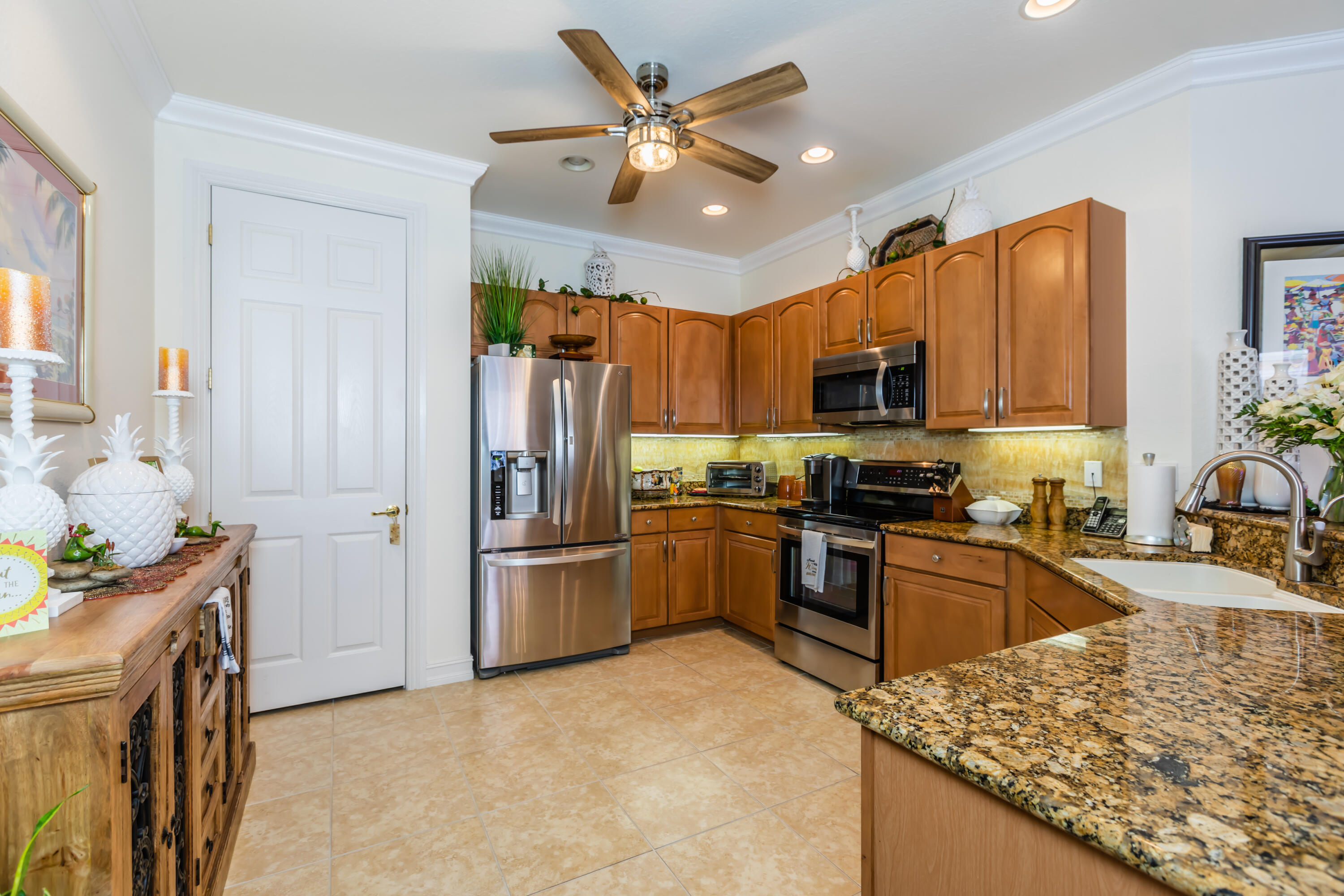 14728 Cranberry Naples Naples, FL 34114 - Photo 9 of 26 a kitchen with stainless steel appliances granite countertop a refrigerator stove top oven a sink and dishwasher