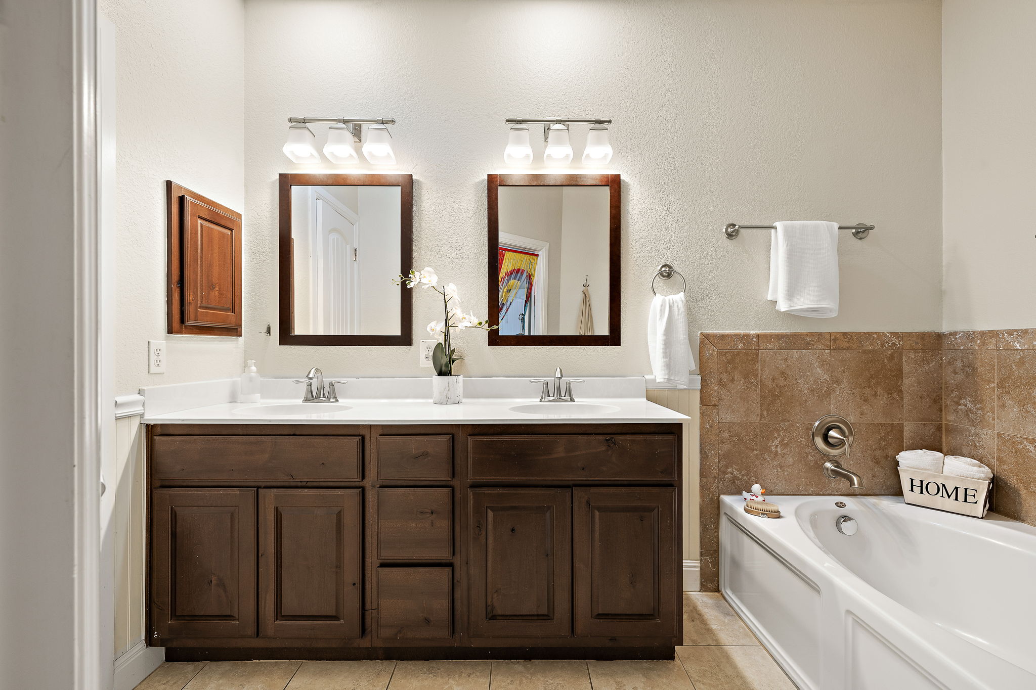 6708 Menchaca Road, Unit 10 Austin, TX 78745 - Photo 17 of 28 Double vanity with wood-finish cabinetry, white countertops, and chrome fixtures
