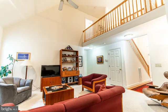 a living room with furniture a flat screen tv and bookshelf