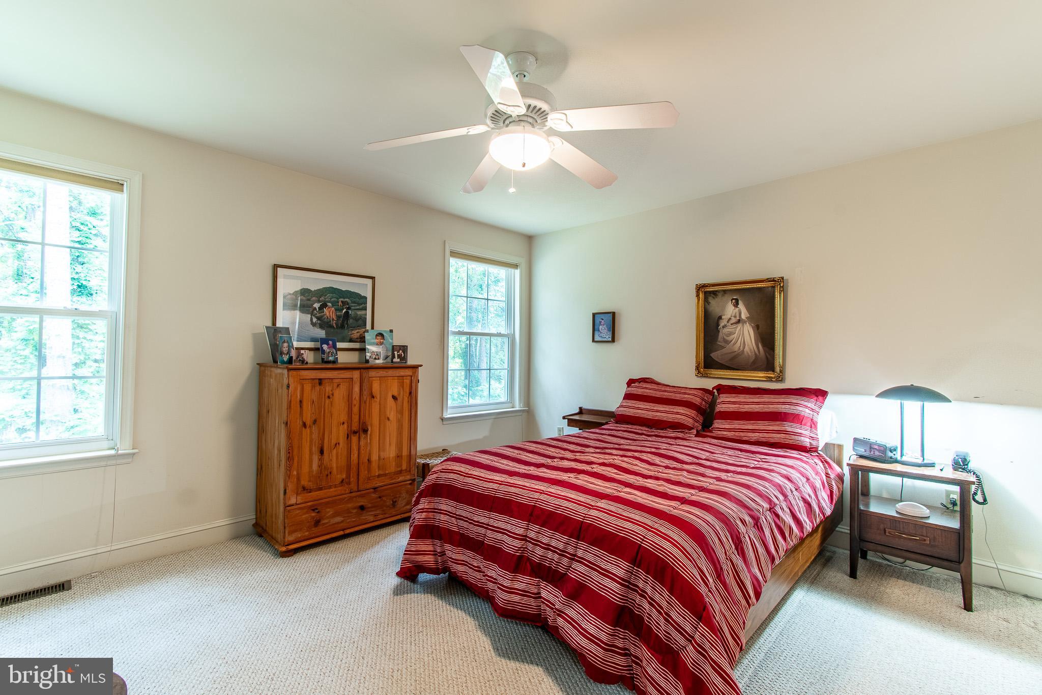 228 Tyler Avenue St. Michaels, MD 21663 - Photo 15 of 44 a bedroom with a bed and a chandelier
