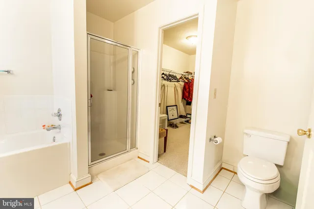 a bathroom with a granite countertop shower and a toilet