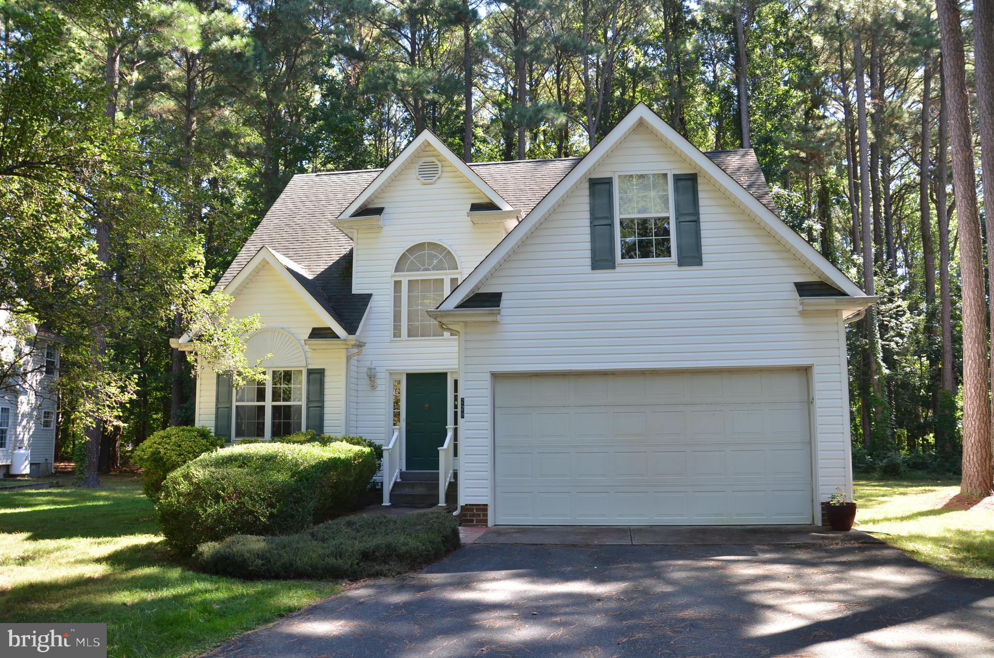 228 Tyler Avenue St. Michaels, MD 21663 - Photo 2 of 44 a front view of a house with a yard