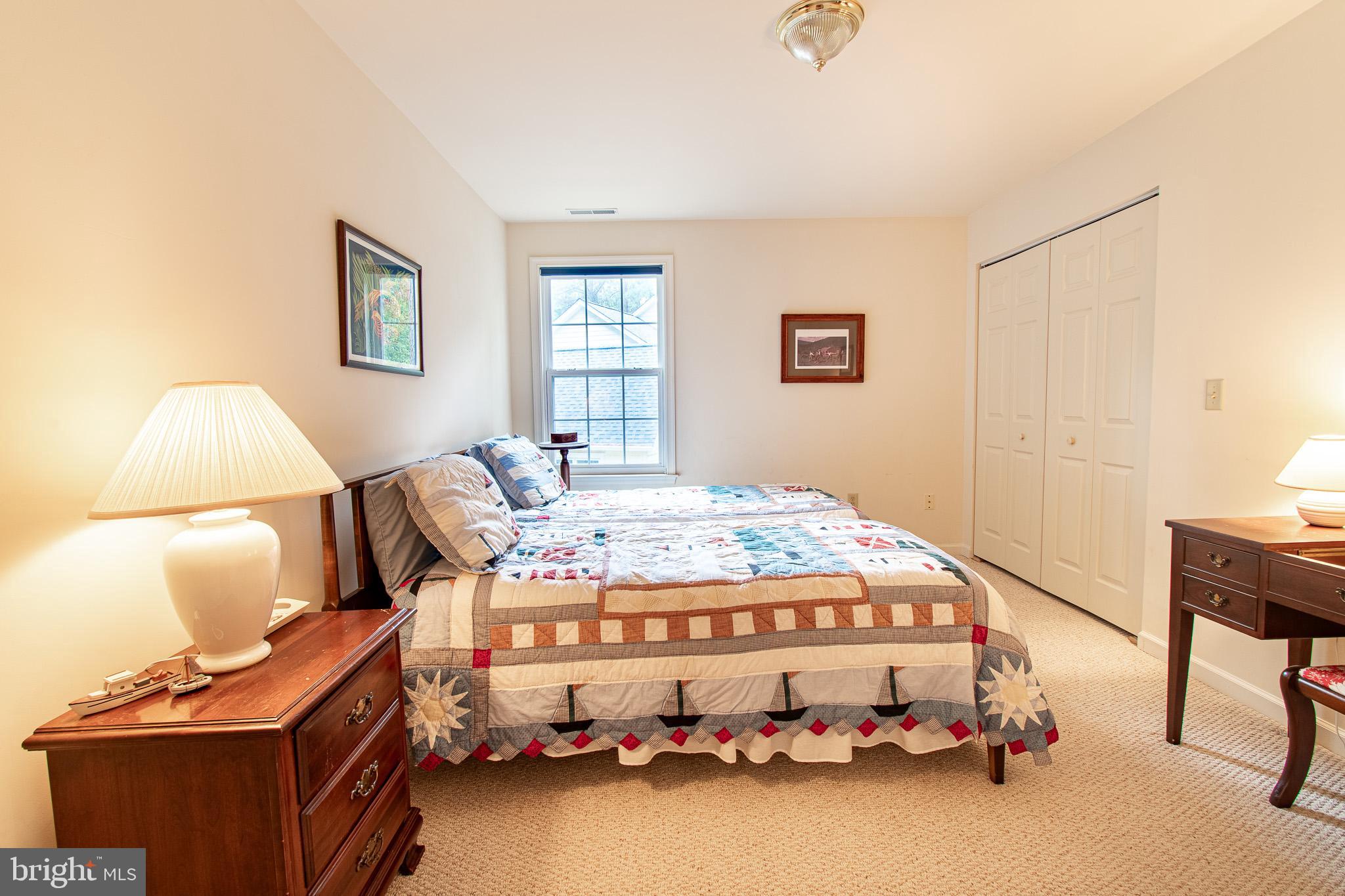 228 Tyler Avenue St. Michaels, MD 21663 - Photo 21 of 44 a bedroom with a bed and a window