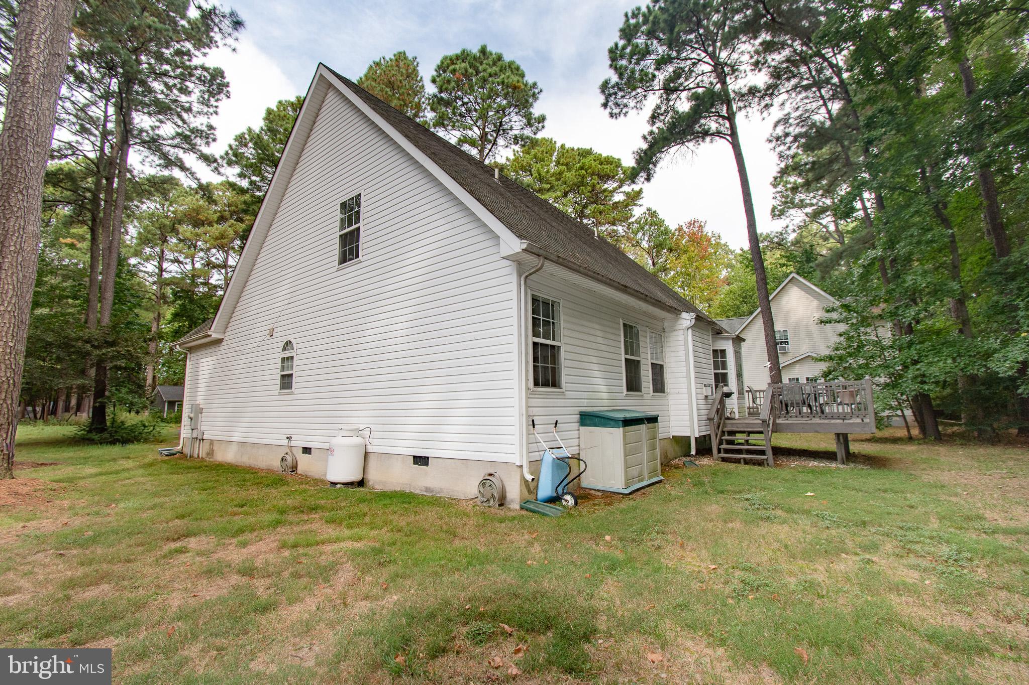 228 Tyler Avenue St. Michaels, MD 21663 - Photo 29 of 44 a view of a white house with a yard and a large tree