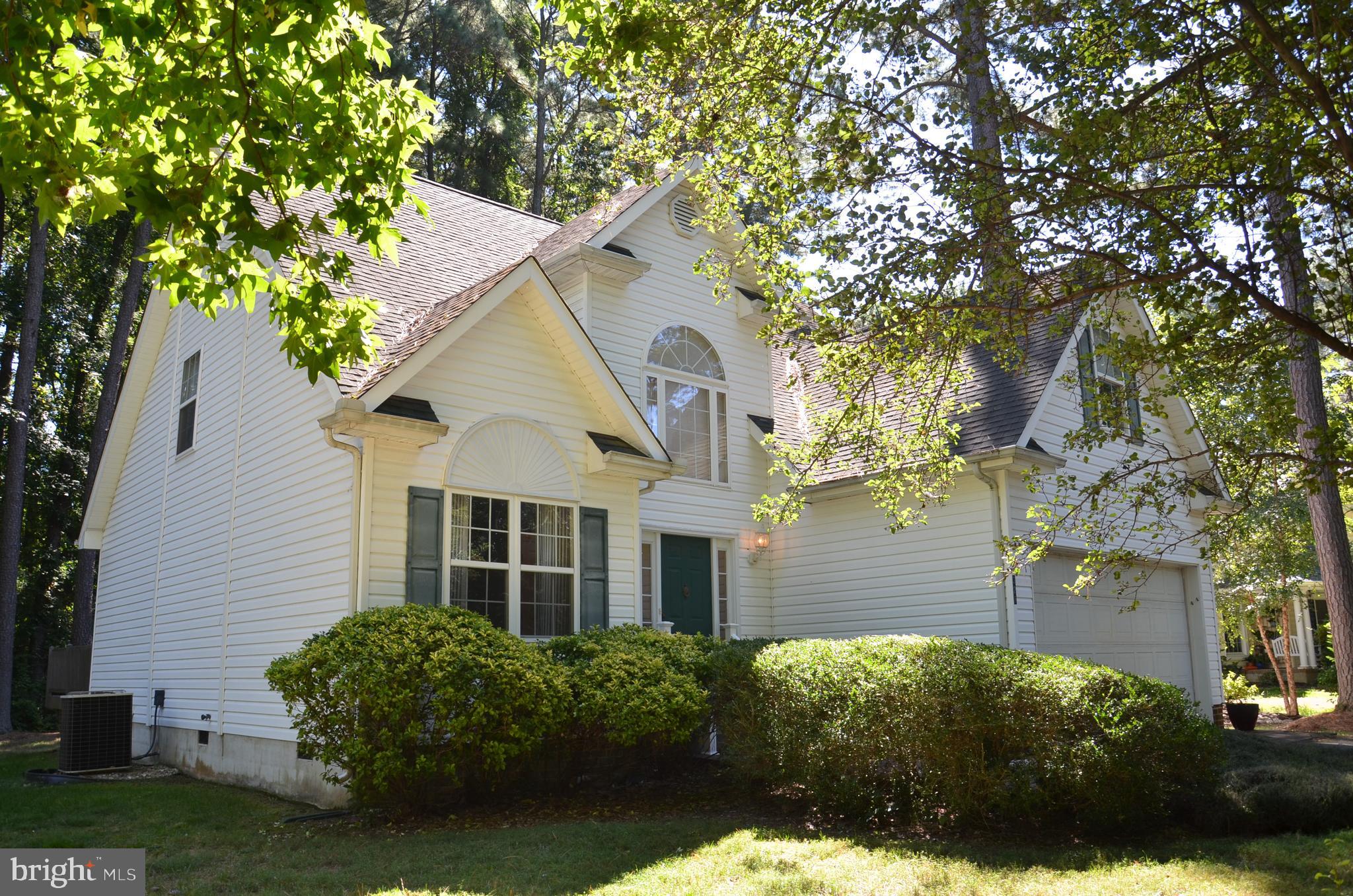 228 Tyler Avenue St. Michaels, MD 21663 - Photo 3 of 44 a front view of a house with garden