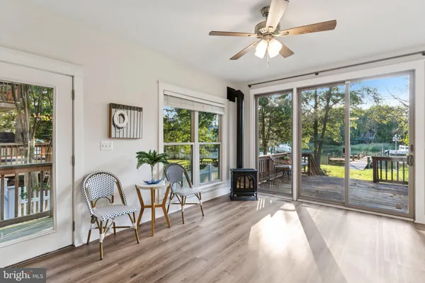 a living room with furniture and a large window with wooden floor