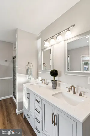 a bathroom with double vanity sink and a mirror