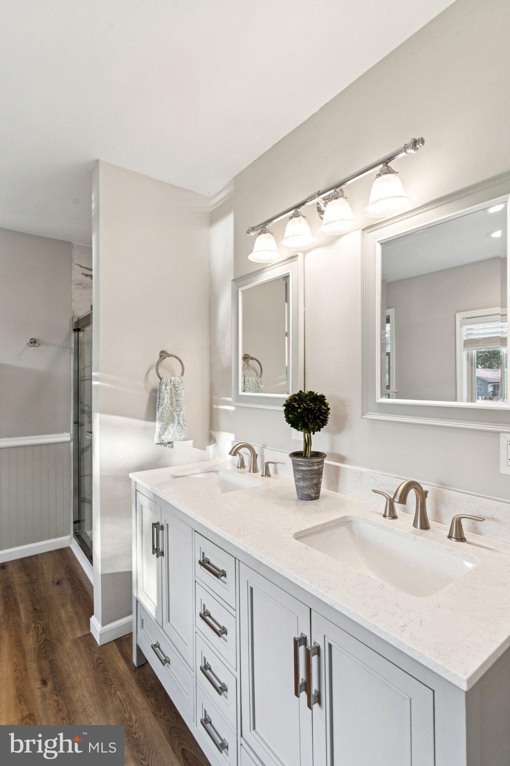 4922 Lerch Drive Shady Side, MD 20764 - Photo 17 of 56 a bathroom with double vanity sink and a mirror