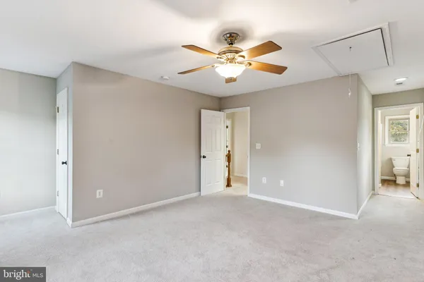 a view of an empty room with a fan