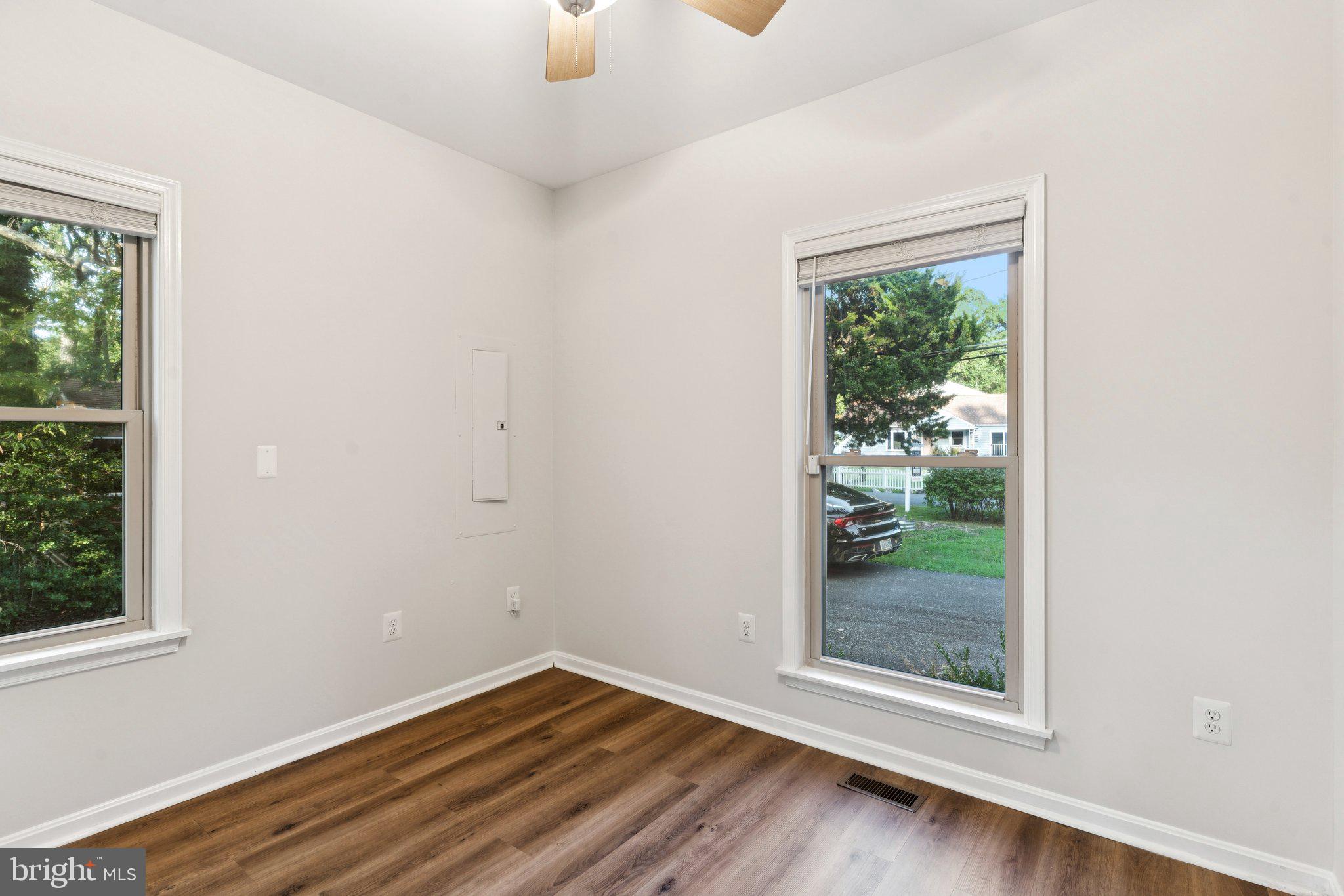 4922 Lerch Drive Shady Side, MD 20764 - Photo 26 of 56 an empty room with wooden floor and windows