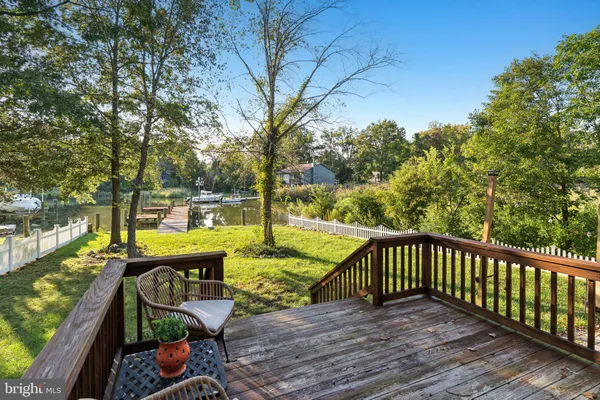 a view of a roof deck with wooden floor and fence