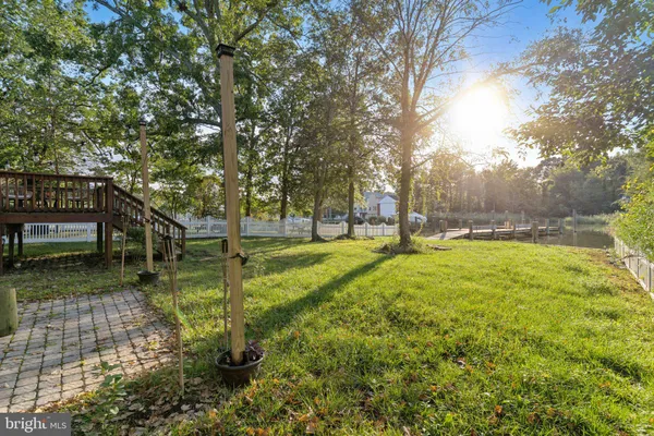 a view of yard with swimming pool and trees