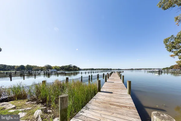 a wooden pier with boats in it