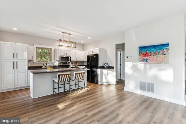 a kitchen with stainless steel appliances a refrigerator and a stove top oven