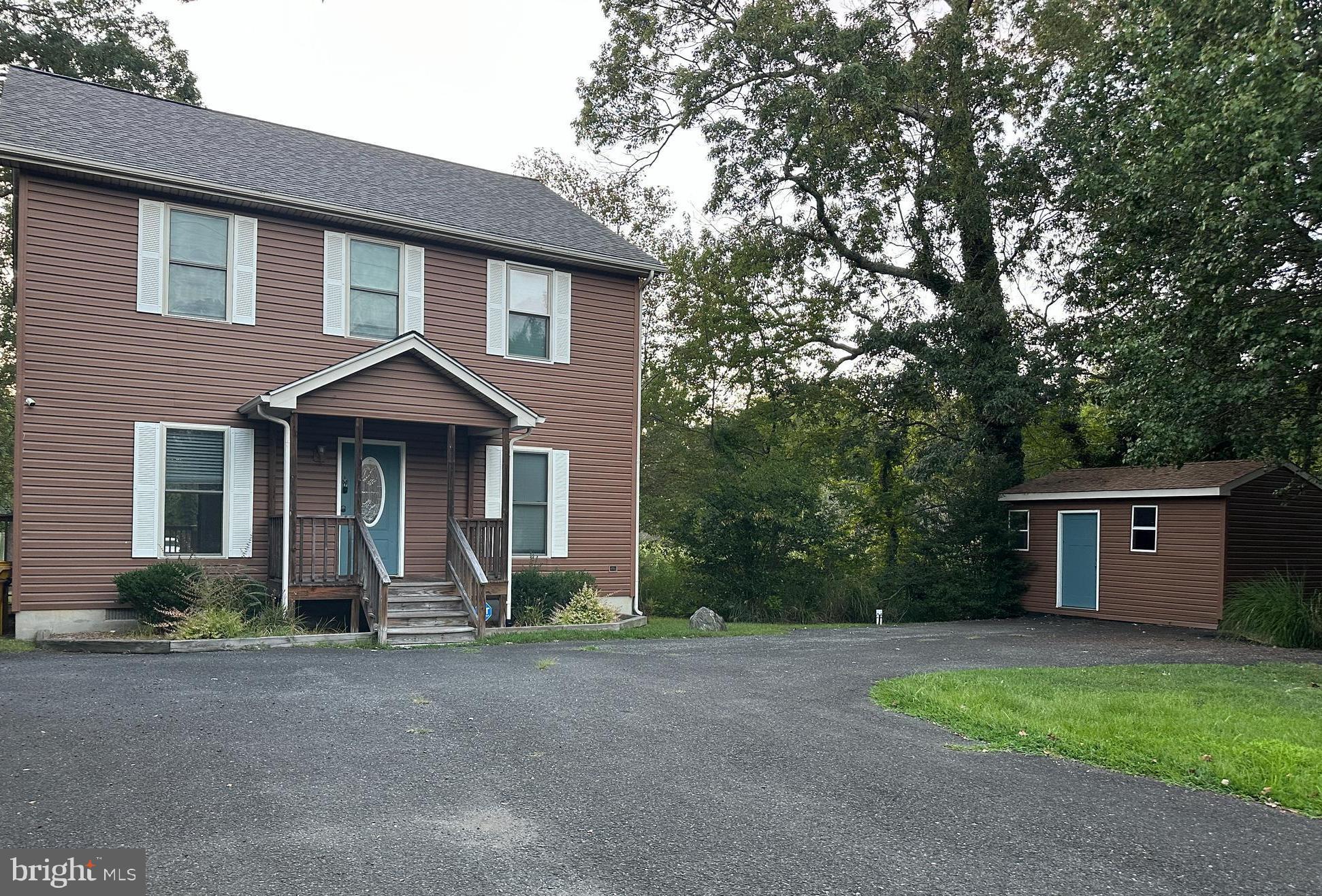 4922 Lerch Drive Shady Side, MD 20764 - Photo 46 of 56 a front view of a house with a yard and a garage