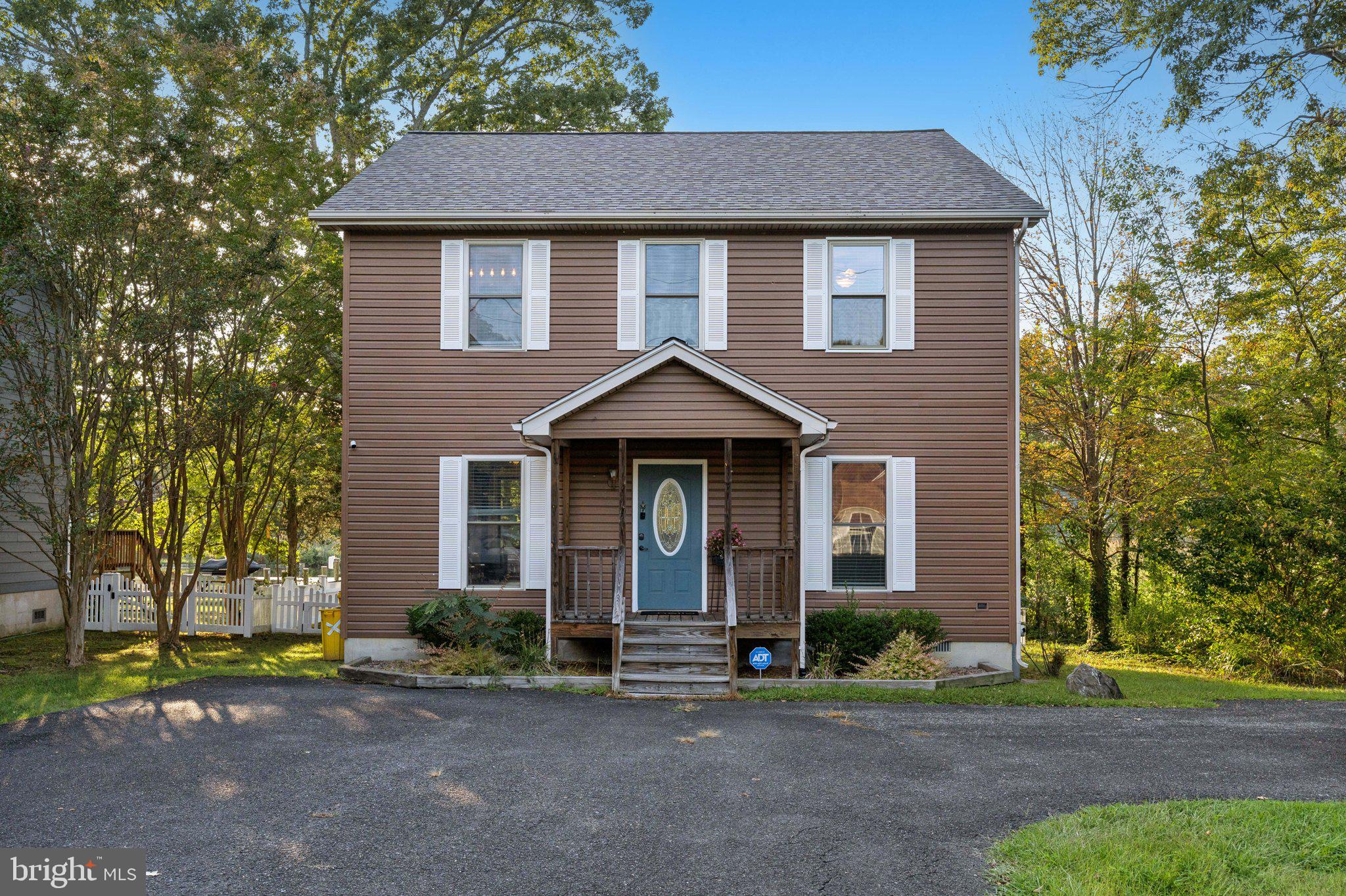 4922 Lerch Drive Shady Side, MD 20764 - Photo 53 of 56 a front view of a house with a yard and garage