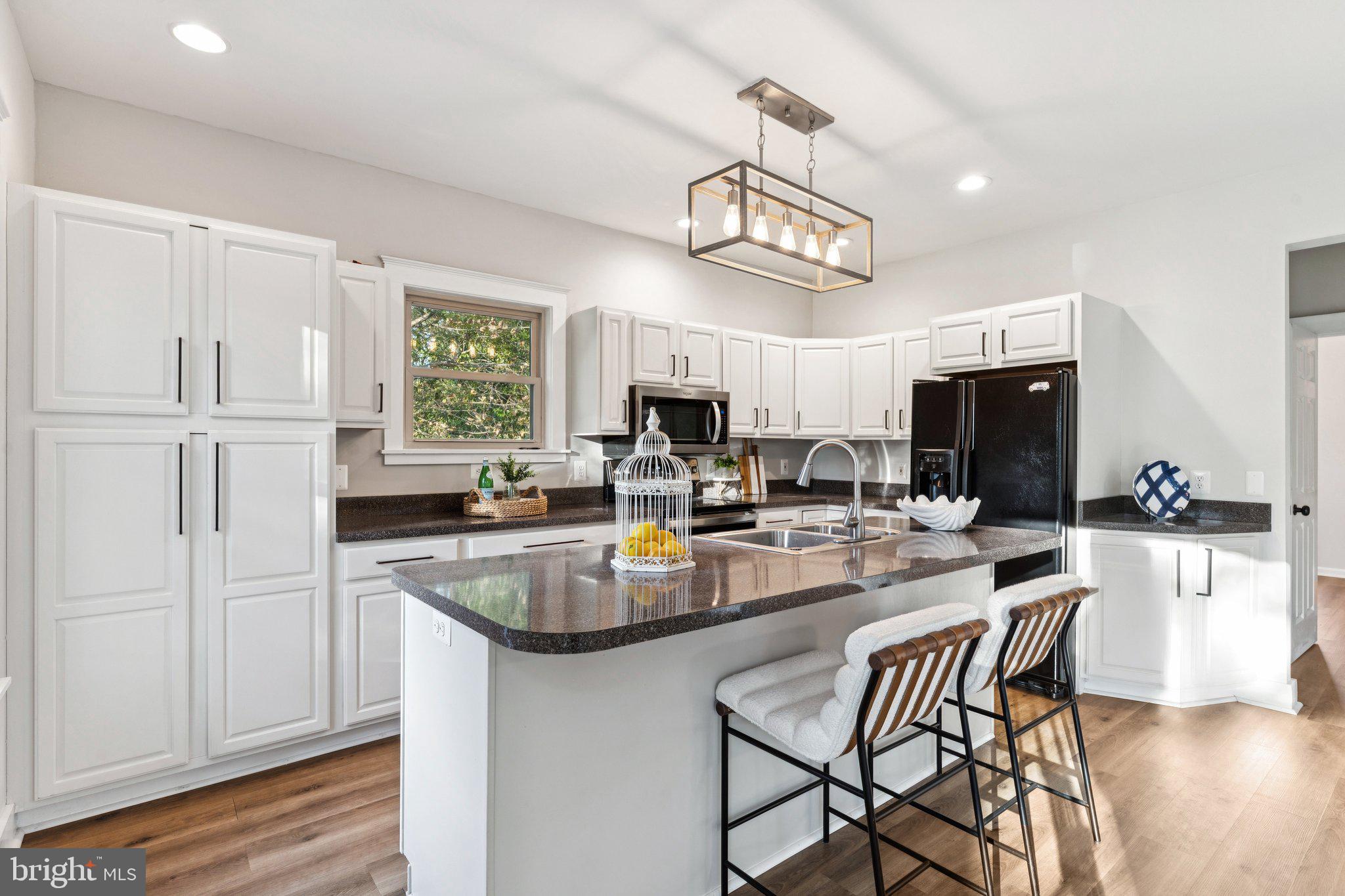 4922 Lerch Drive Shady Side, MD 20764 - Photo 6 of 56 a view of a dining room with furniture a kitchen and chandelier