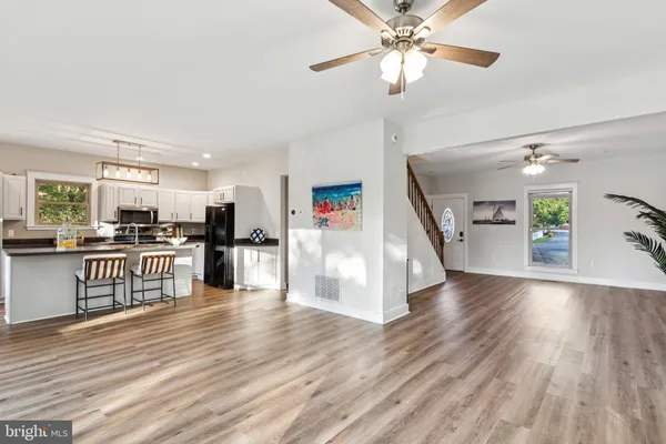 a view of a kitchen with wooden floor and electronic appliances