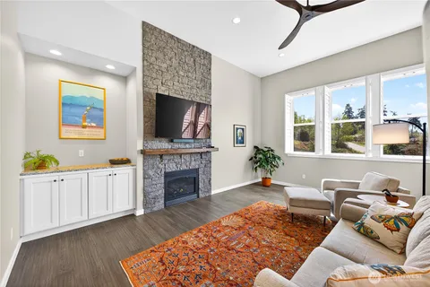 a living room with furniture fireplace and flat screen tv
