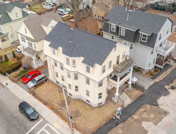 an aerial view of residential houses with outdoor space