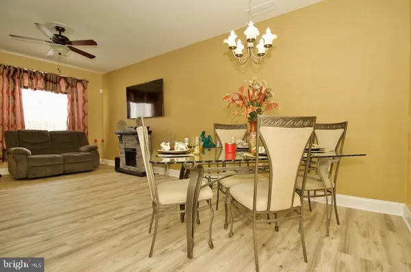 a view of a dining room with furniture and a chandelier