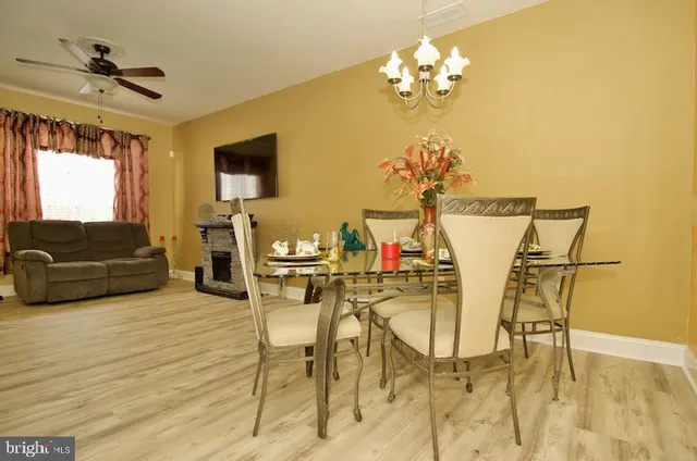 a view of a dining room with furniture and a chandelier