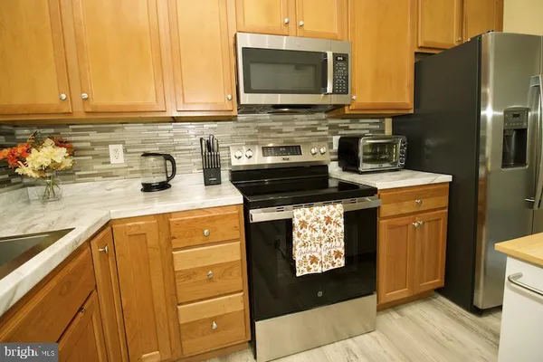 a kitchen with a stove a sink and a microwave