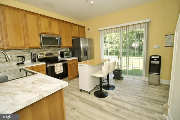a kitchen with a sink a counter and chairs
