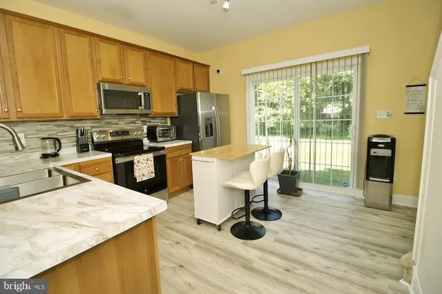 a kitchen with a sink a counter and chairs