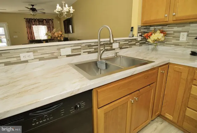 a kitchen with sink and cabinets