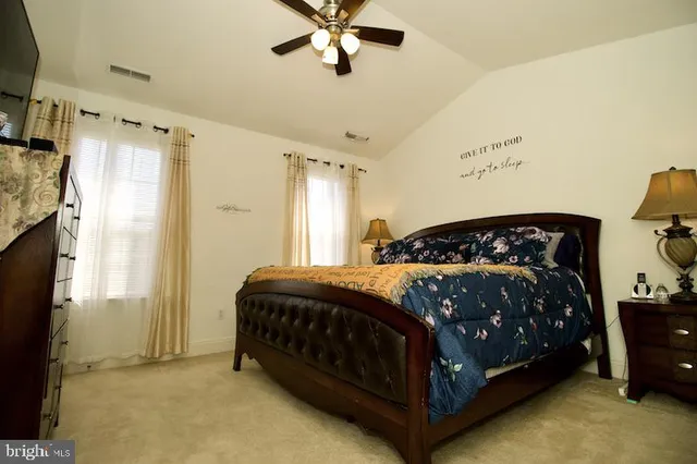 a bedroom with a bed lamp and a fireplace