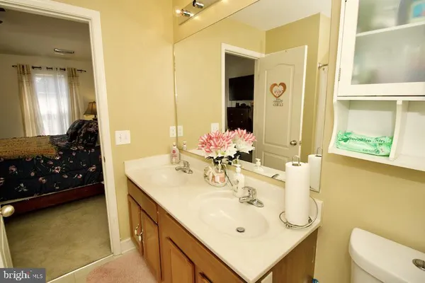 a bathroom with a sink vanity and a mirror