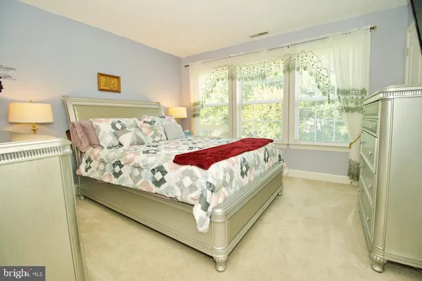 a bed sitting in a bedroom next to a window