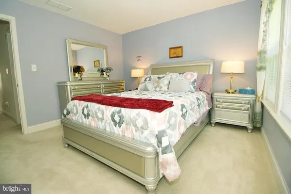 a bedroom with bed and window