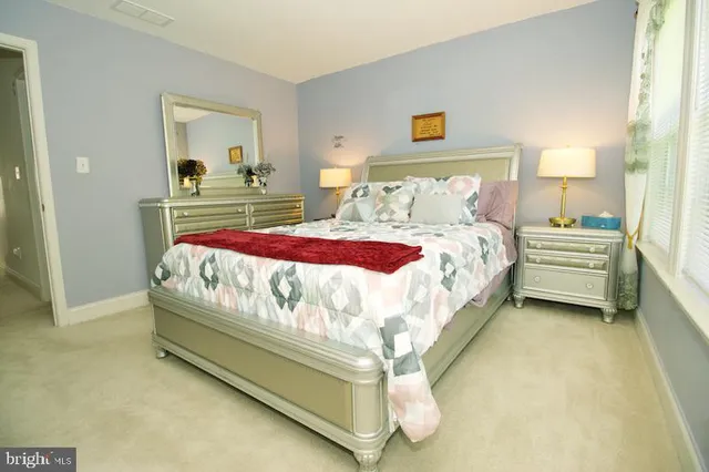 a bedroom with bed and window