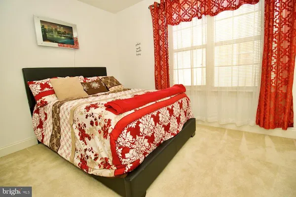 a bed sitting in a bedroom next to a window