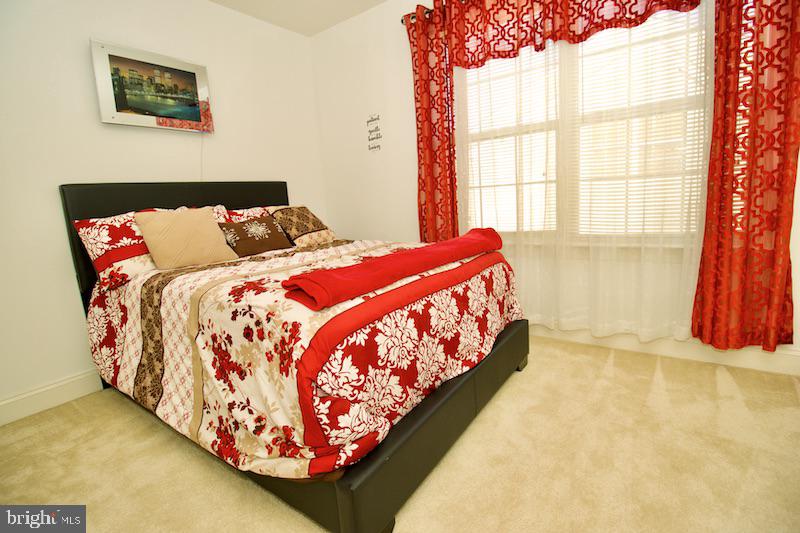 162 Lexington Place Dover, DE 19901 - Photo 35 of 48 a bed sitting in a bedroom next to a window