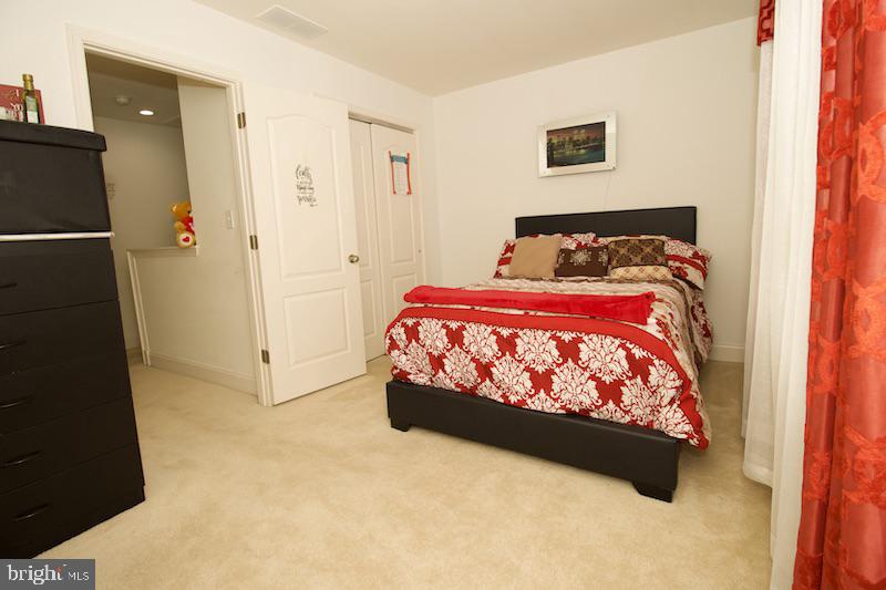 162 Lexington Place Dover, DE 19901 - Photo 36 of 48 a bed sitting in a bedroom next to a cabinet