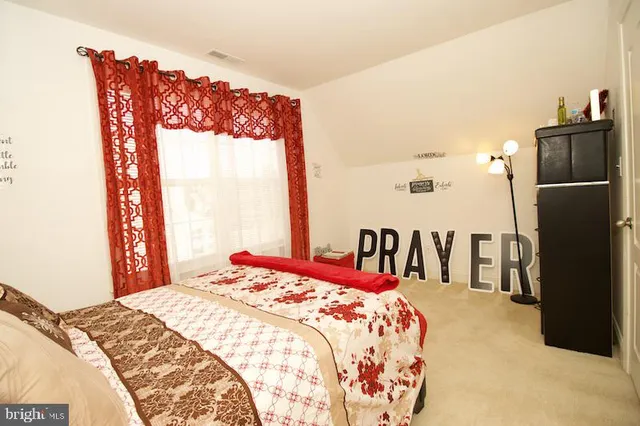 a bedroom with a bed and a large mirror