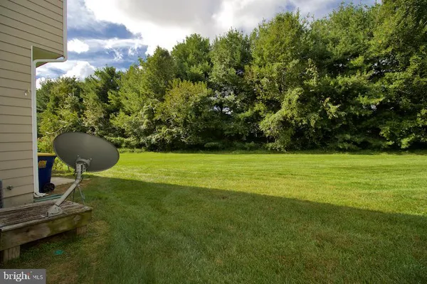 a view of a backyard with table and chairs and potted plants