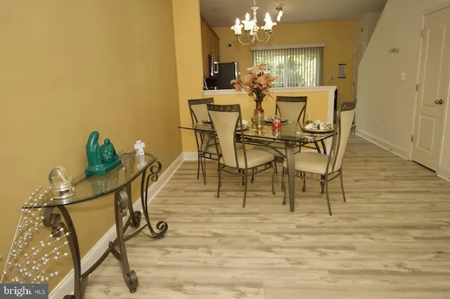 a view of a dining room with furniture and a chandelier