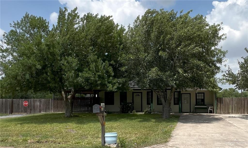 a view of a backyard with a cabin and a chair